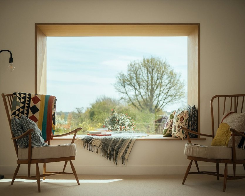 The bay window forms an oak-lined reading nook.