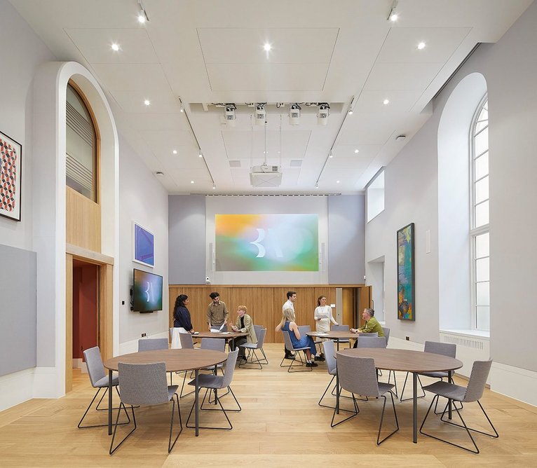 Light reaches the lecture room through a narrow basement lightwell immediately outside.