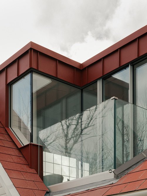 Coated red steel is robust and echoes existing roof tiles.