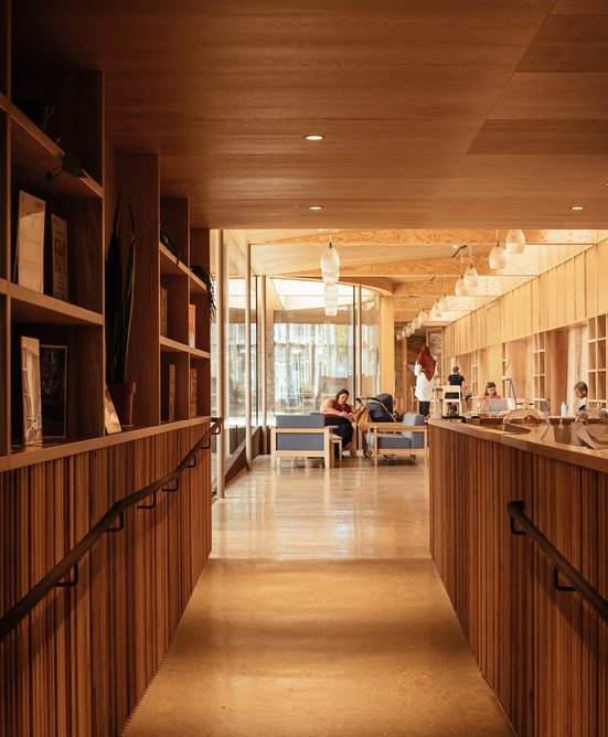 The ramp alongside the kitchen is enlivened by shelving.