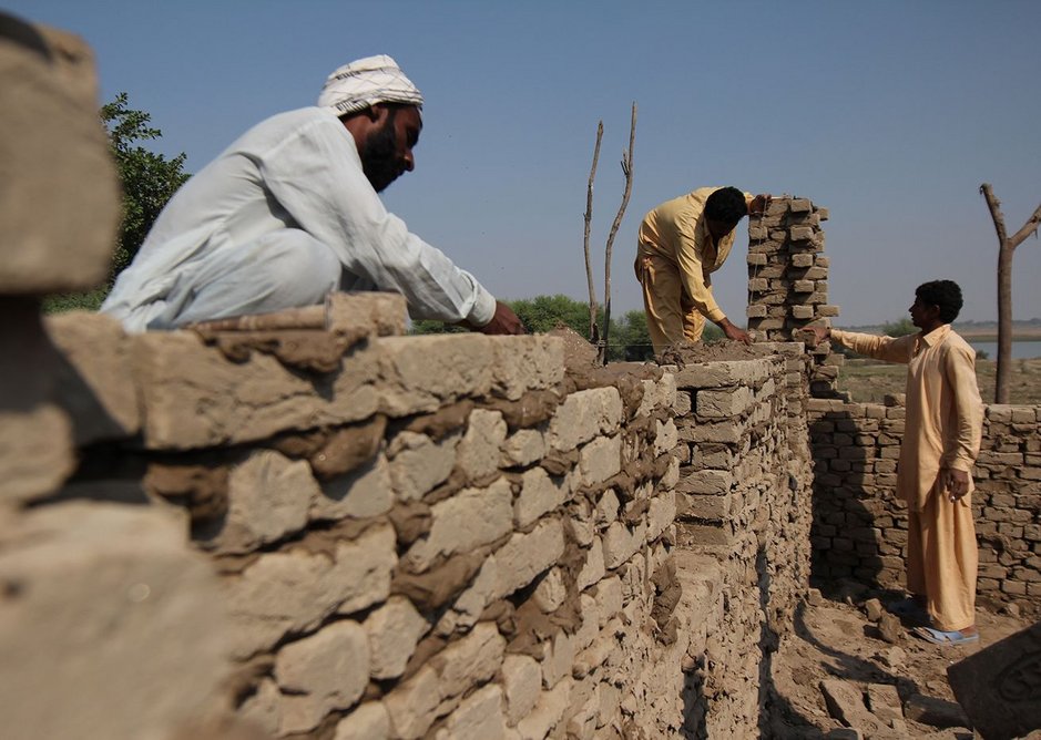 Villagers build a flood-proof mud brick house to Yasmin Lari's design.