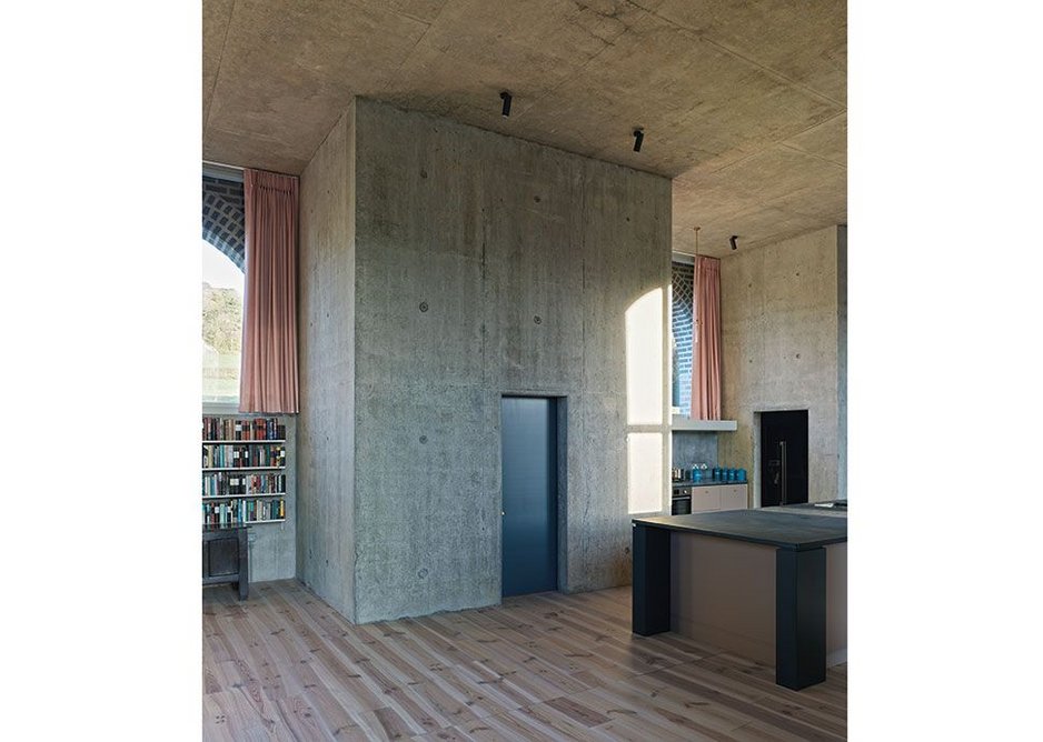 The concrete towers rising through the main space contain lesser spaces – here there is a small study.