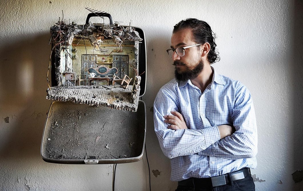Mohamad Hafez with one of his suitcase sculptures.