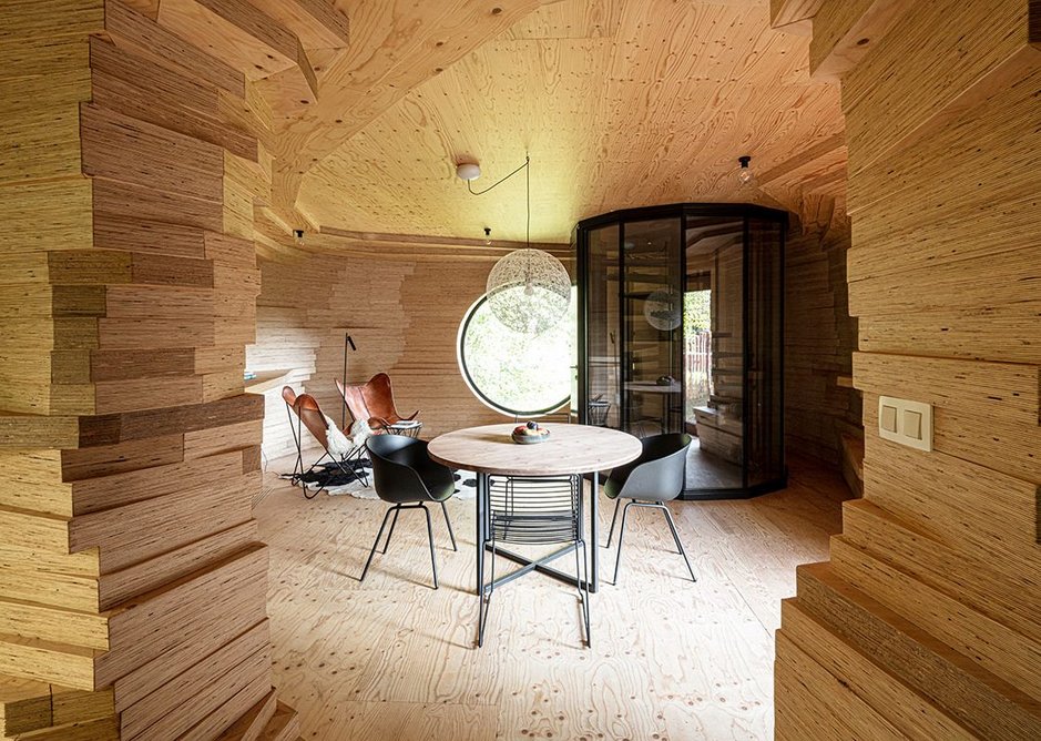 Sunny, cosy upper levels. The guest rooms become contoured caves made of layers timber.