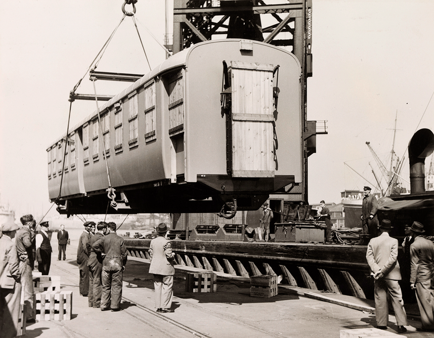 The first consignment of 28 railway carriages for Kenya & Uganda railways arriving at the Royal Albert Dock, lifted by the London Mammoth, 1947