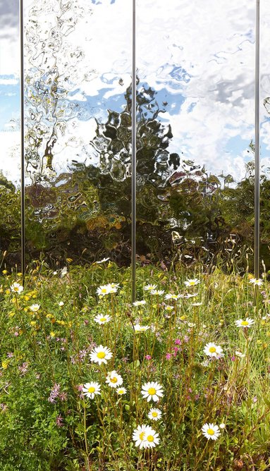 Stainless steel cladding plays with the planting, reflecting and rippling.