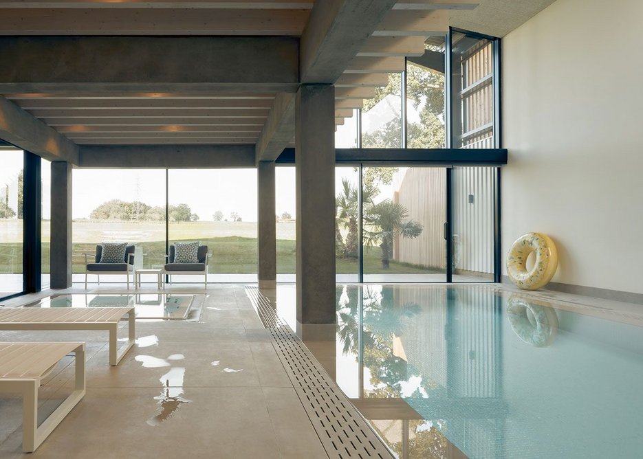 The swimming pool occupies as much of the ground floor as the living area.