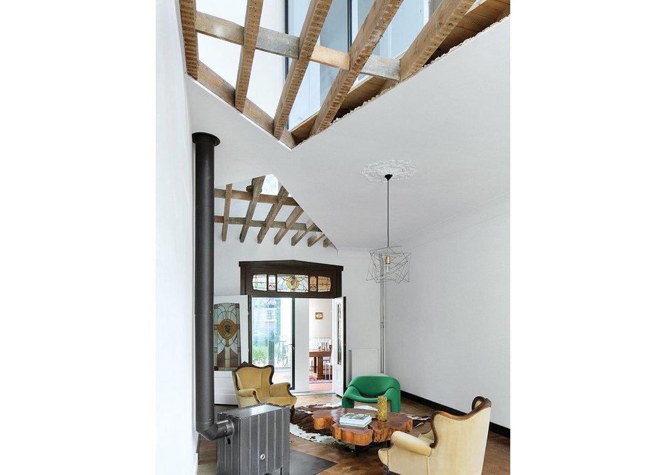 With the ceiling cut open to reveal the first floor windows, light pours into the living room.