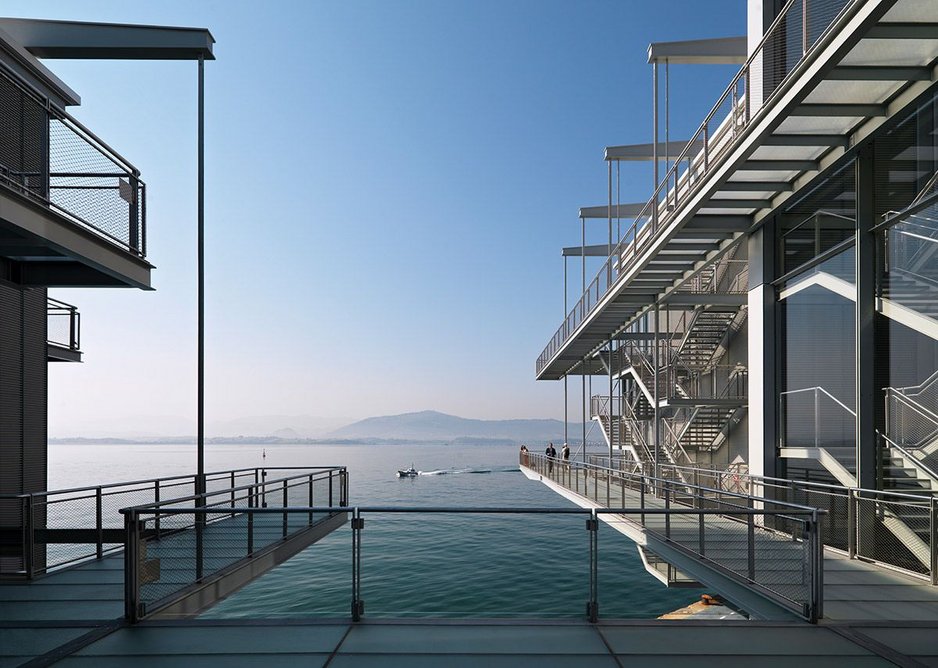 Looking south from the Pachinko, all the circulation is externally expressed. The raised public space with its glass floor cantilevers out into the bay.