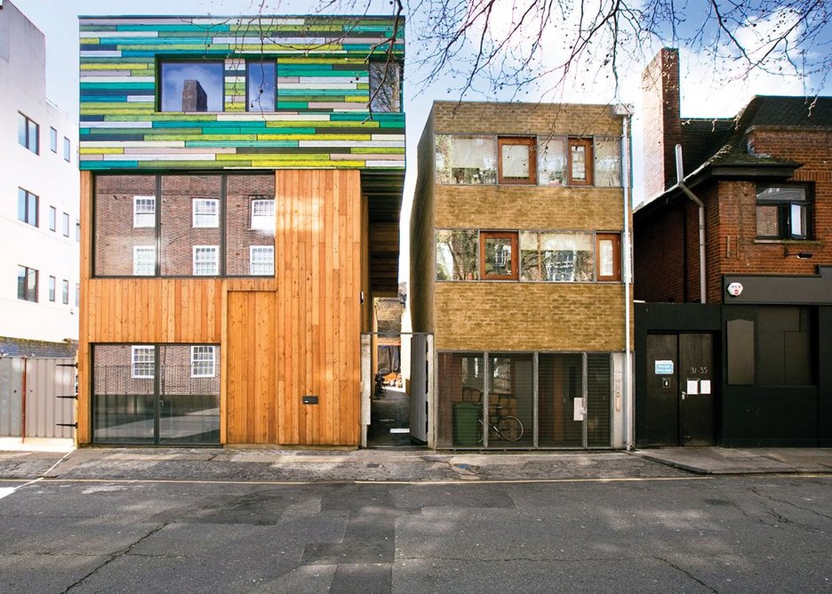 Unpainted larch clads the studio, topped by the living section wrapped in horizontal painted plywood.