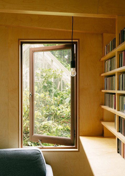 A window provides additional light and secluded views to the reading corner.