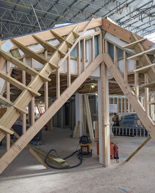 The timber carcassing structure for the same corner, constructed in the workshop before being delivered to site.