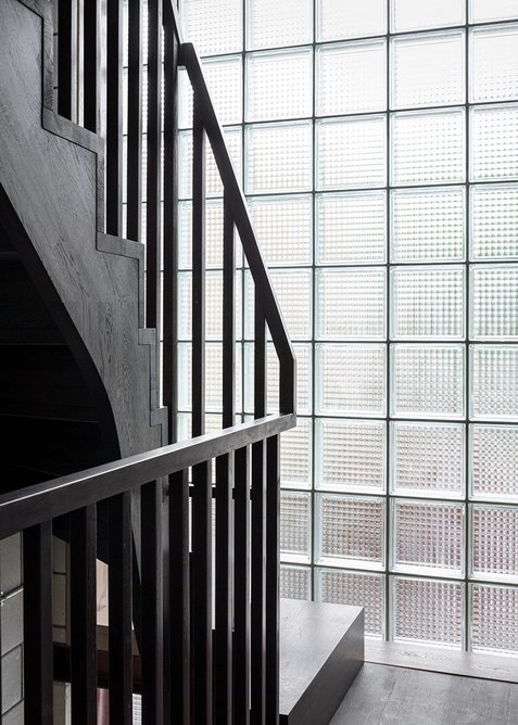 Staircase constructed from steel and dark-stained wood.