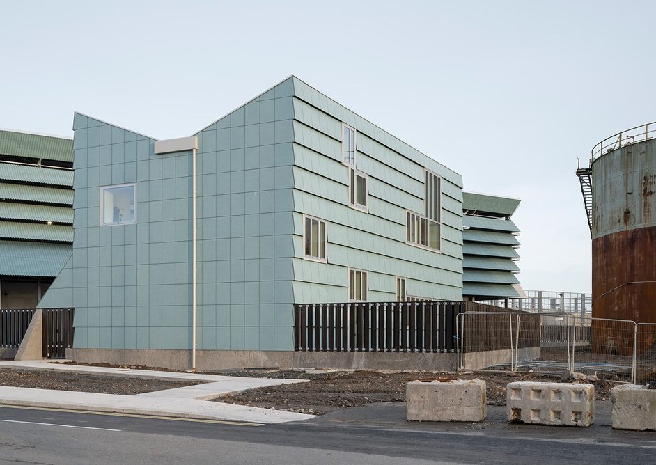 A small lab building sits at the site entrance.