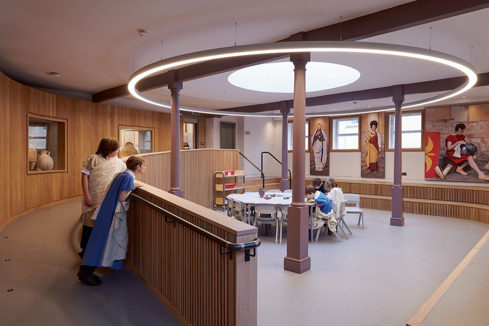 This learning room is configured comfortably around the four original cast iron columns, encircled by the ramp and over-sized steps.