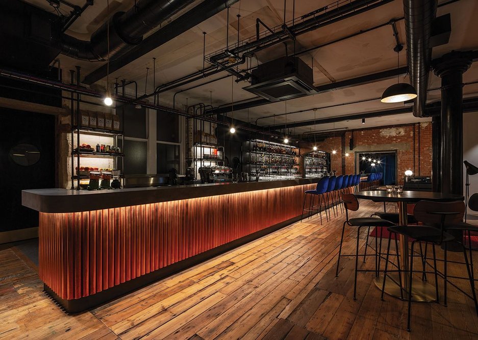 The bar on the ground floor is faced with bronzed scaffolding poles.