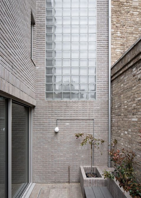 Garden to the ground-floor flat. Cast glass blocks admit light to the stairs to the upper floor flat.