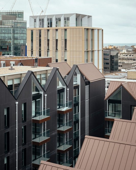 The gabled roofline of the private rented housing lends a domestic character that is familiar to the city.