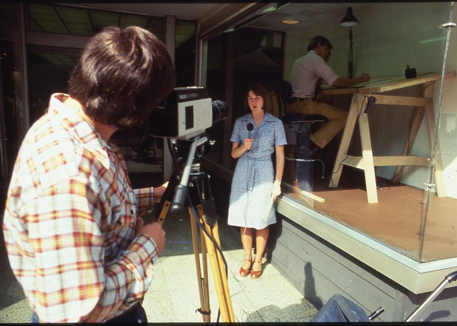An architect from Moore Grover Harper at work while on display in the window of the Riverdesign Dayton storefront office, 1976.