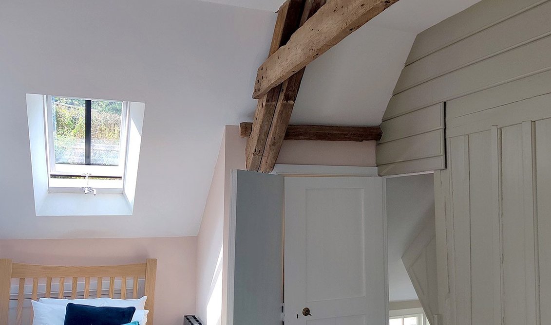 New roof windows light an attic bedroom.
