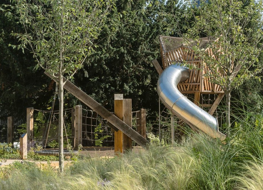 The natural materials and planting help the playground blend into the gardens around it.