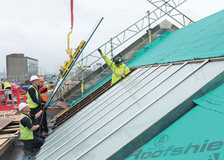 Installing the glass on one of the rooftop studios.