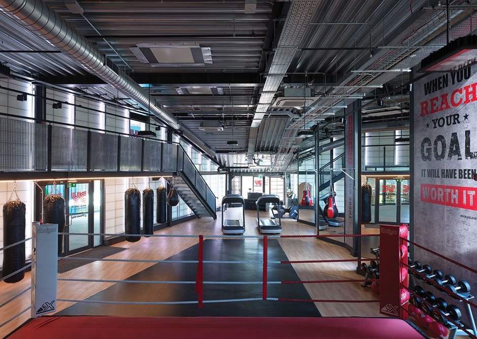 Featherstone Young considered prefabrication for speed but ultimately opted for steel frame – here left exposed in the boxing gym –  because there wasn’t the head height for anything that needed to be craned in.