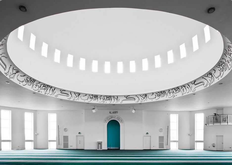 The interior of the Baitul Futuh Mosque is restrained and simple, with a large central dome and floor to ceiling windows.