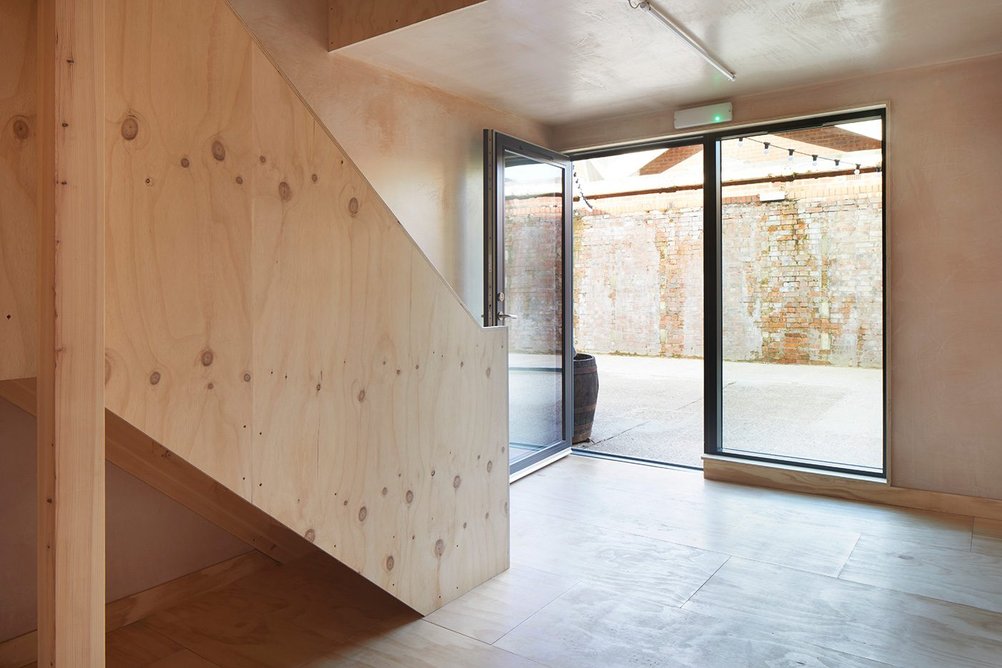 A simple timber staircase leads the user up to the first floor meeting room.