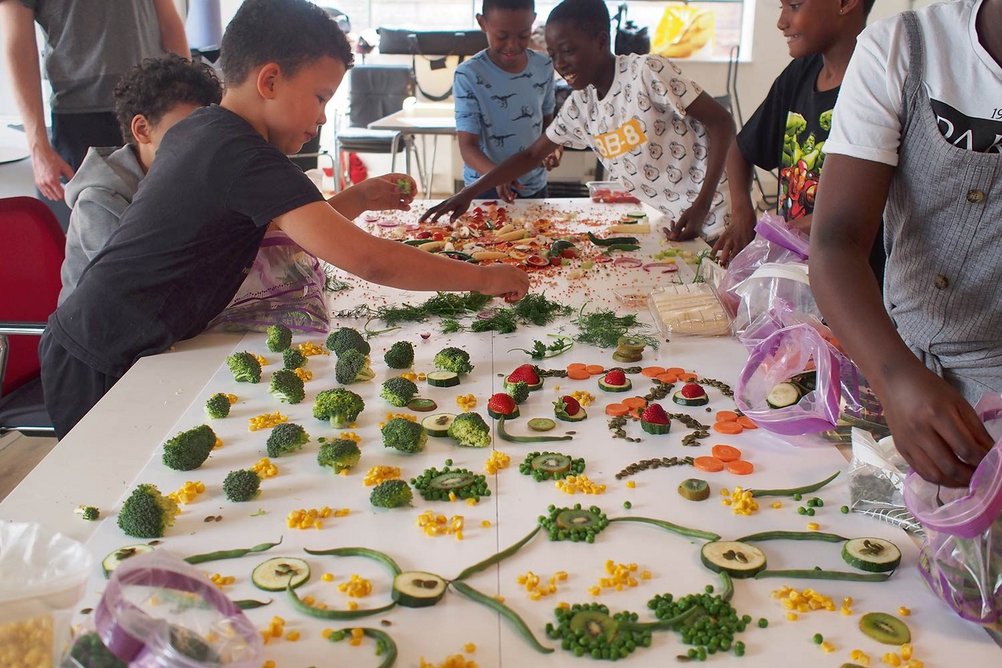 Patterns made with fruit and vegetables at youth club workshops informed the branding of Nourish Hub.