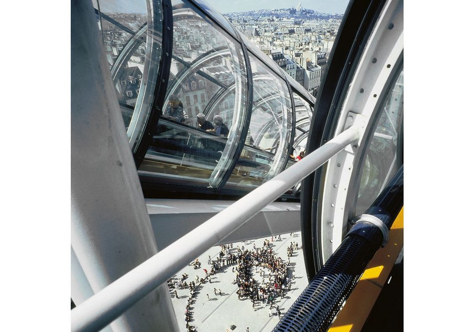 Visitors enjoy the view towards Montmatre from the escalators.