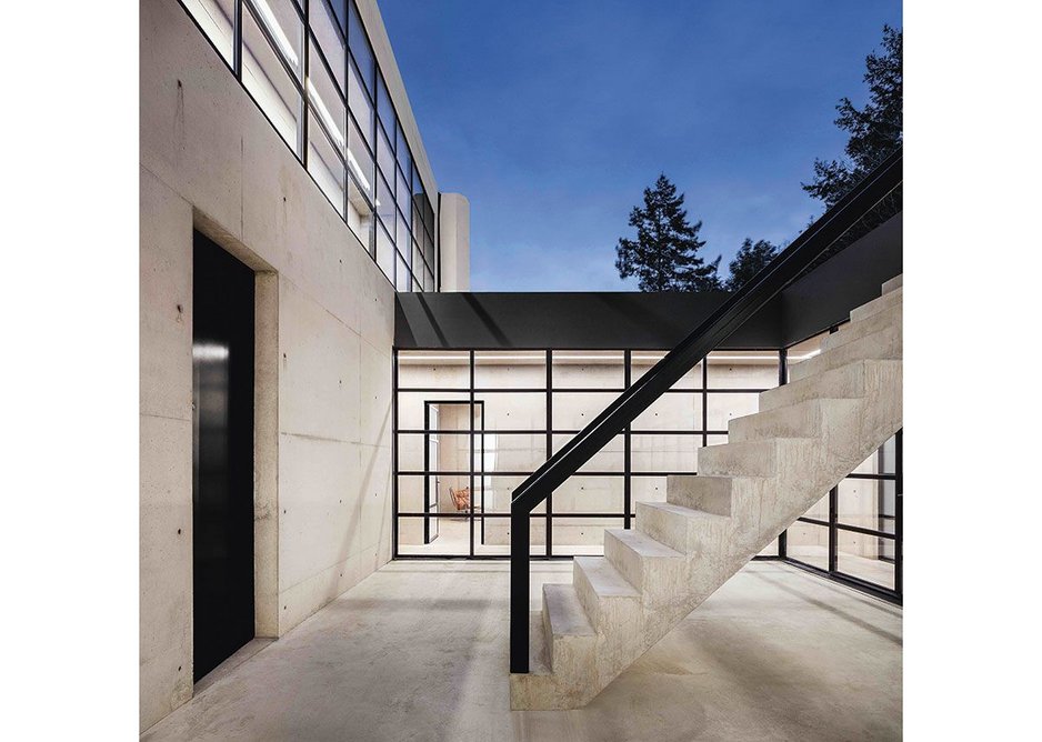 A stair from ground floor leads down to the entrance courtyard and front door, following the existing contours of the land.