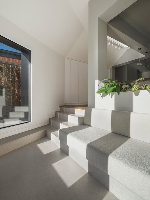 View from the sunken living space back towards the kitchen, a planter separates the two.