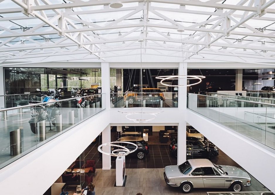 Ultra-transparent glass balustrades keep the Cotswold Cheltenham BMW showroom bright and the stock fully visible.