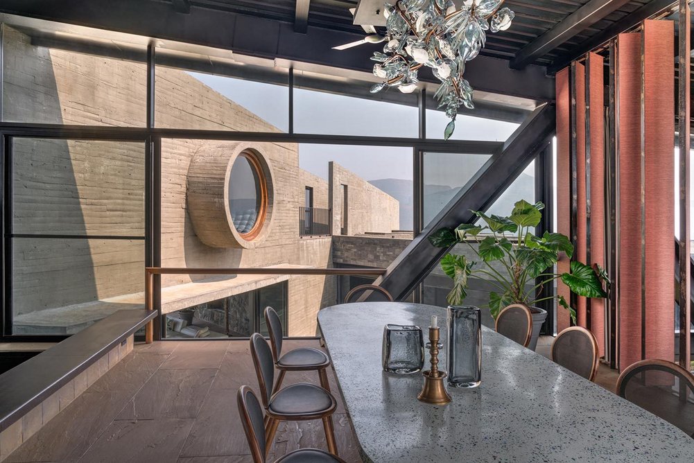 The 10-foot terrazzo dining table with view onto round reading window.