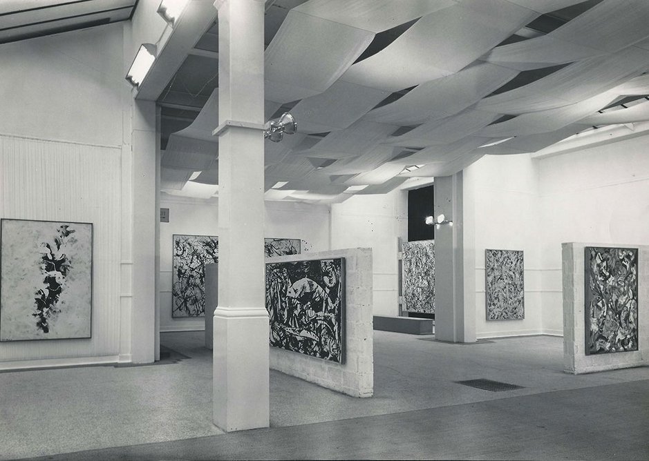Installation view of Jackson Pollock exhibition 1958, designed by Trevor Dannatt at the Whitechapel Gallery. © Whitechapel Gallery. The installation featured an assemblage of breezeblock walls, fabric canopy and carpet to create a space within a space.