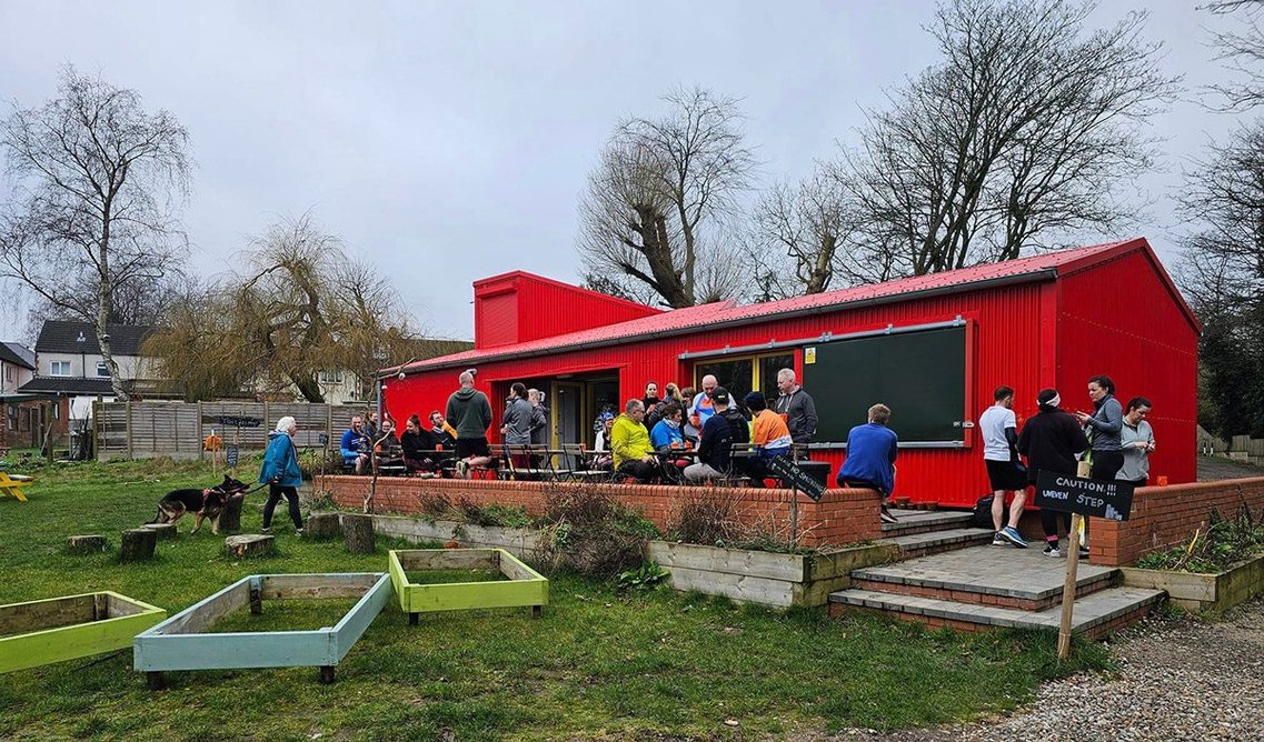 Birmingham Settlement Nature and Wellbeing Centre by Axis Design Architects: The bright red community café provides shelter and facilities.