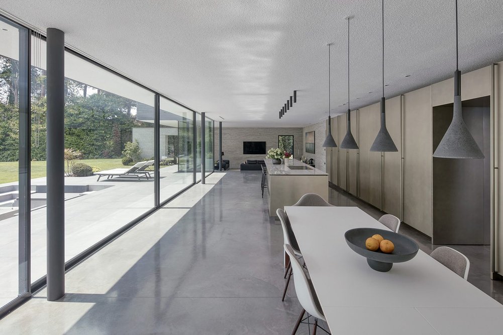 Floor-to-ceiling Maxlight glazing bisects kitchen and garden.