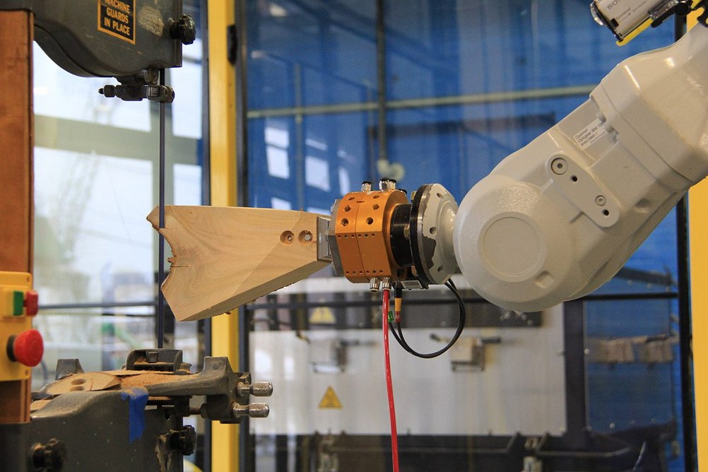 A computer-controlled robotic arm and bandsaw cuts the forks to precise dimensions.