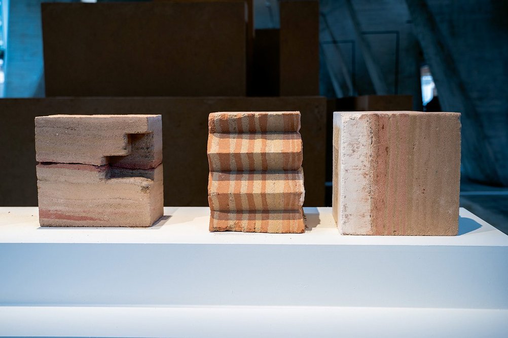 Rammed earth artworks by Jeddah-based Bricklab Studio for a UN exhibition on Diriyah in Paris.