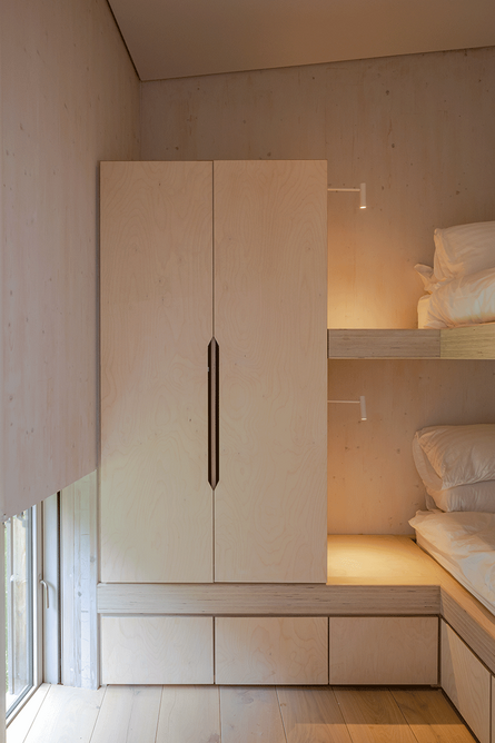 Compact bunk room with bespoke plywood joinery designed to accommodate only as much stuff as absolutely necessary.
