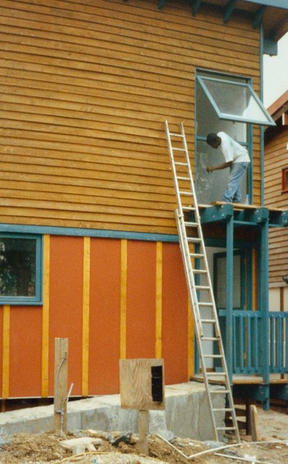 Self-builder painting the timber frames.