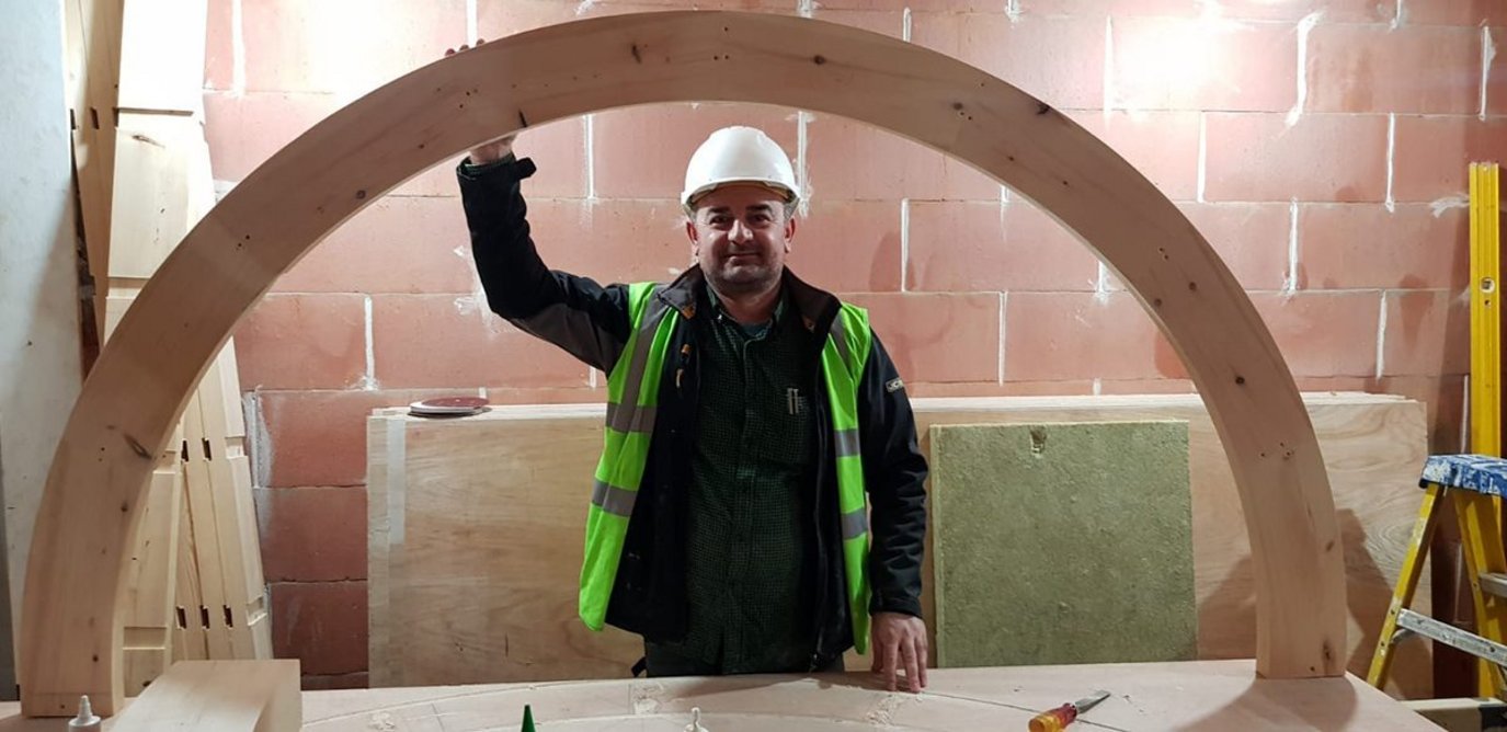 Dritan (Danny) Caka on site at The Library House. He is holding the sole plate to the stair at the centre of the house.