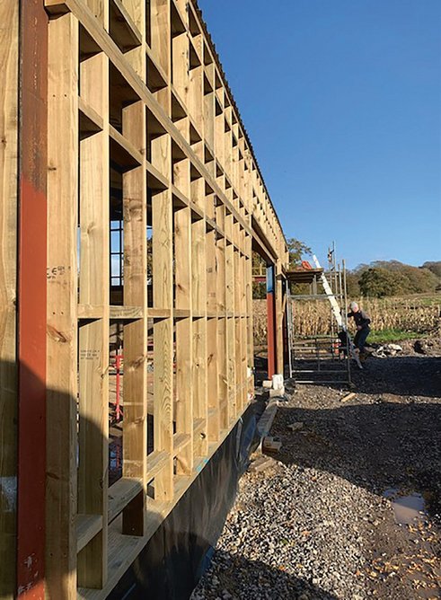 Timber framing is braced by a skin of SterlingOSB Zero to strengthen the structure and provide a backing for the insulation.