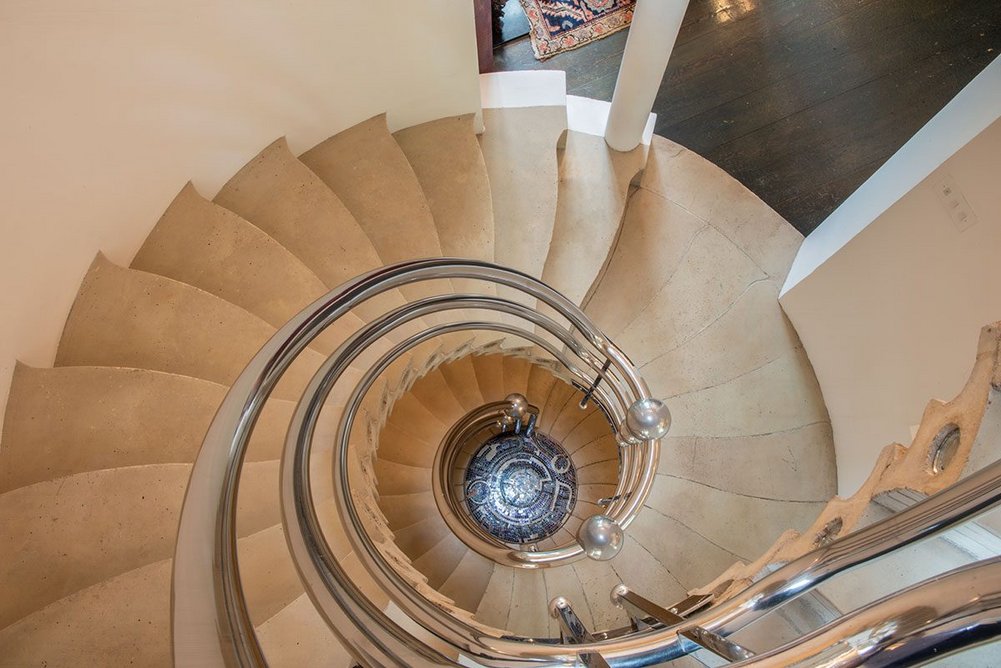 The Solar Stair is a cantilever concrete spiral with Eduardo Paolozzi’s Black Hole mosaic at the base.