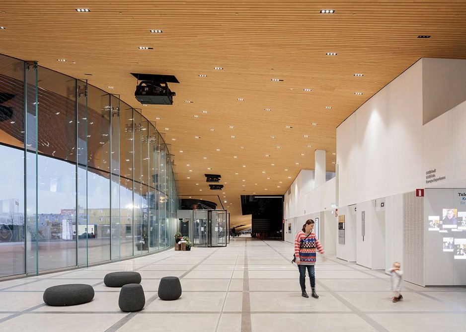 The ground floor looking north. The timber soffit of the cantilever draws the eye to the auditoria at the far end.