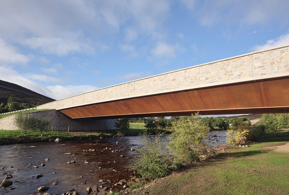 Two trapezoidal steel box girders in weathering steel support the new bridge.