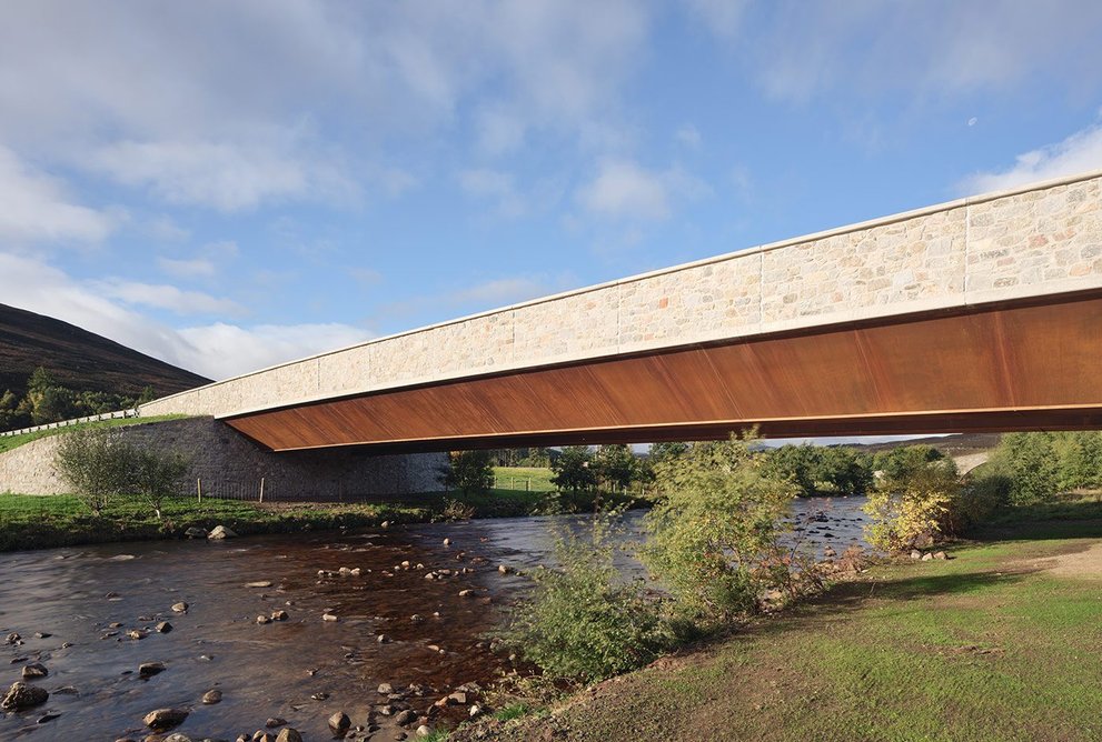 Two trapezoidal steel box girders in weathering steel support the new bridge.