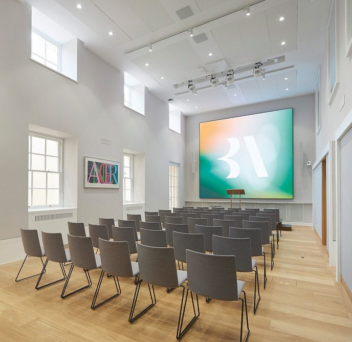 Light reaches the lecture room through a narrow basement lightwell immediately outside.