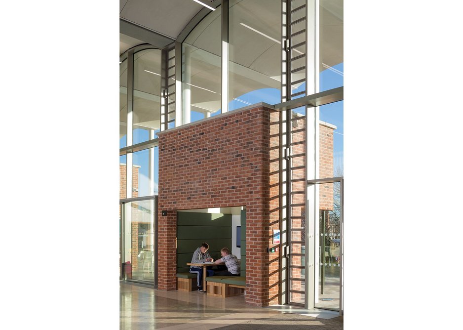 Brick cubes mediate between interior and colonnade, containing semi-private study spaces.